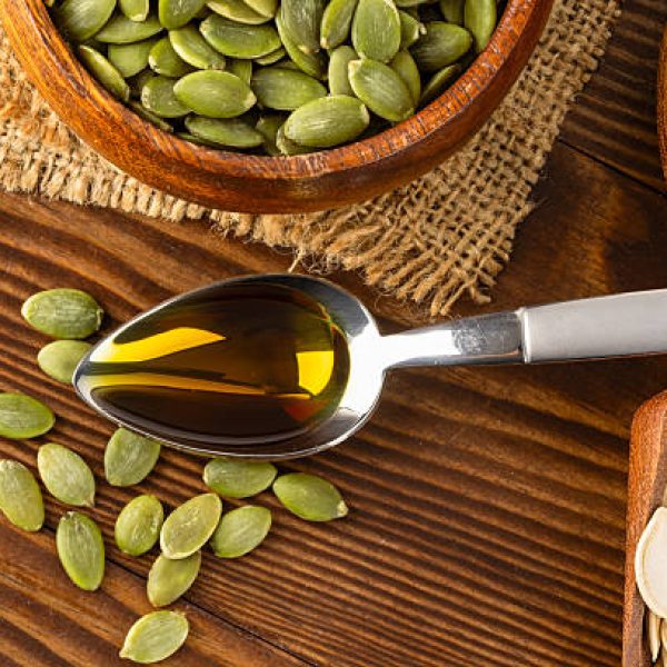 Pumpkin seeds oil on wooden background